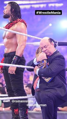 two men standing next to each other in a wrestling ring