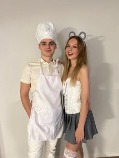 a man and woman dressed up as chefs posing for a photo in front of a white wall