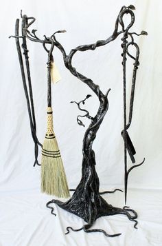 a black tree with two brooms attached to it