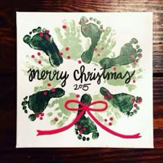 a christmas card with handprints on it