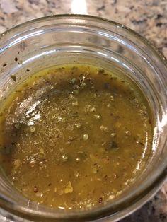 a glass jar filled with liquid sitting on top of a counter