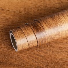 a roll of wood sitting on top of a wooden table