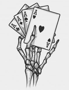 a hand holding four playing cards in it's palm