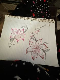 a notebook with two drawings of flowers on the pages and one is drawn in pencil