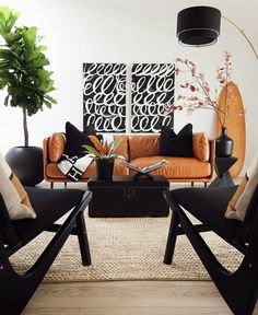 a living room filled with black and orange furniture