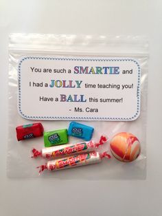 some candy and candies are in a plastic bag with a sign on it that says, you are such a smartie and i had a jolly time teaching you have a ball this summer