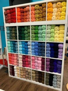 the shelves are filled with yarn and crochet hooks, all in different colors