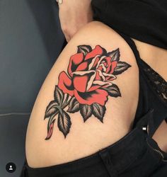 a woman with a rose tattoo on her thigh