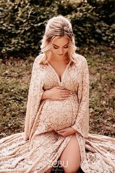 a pregnant woman is sitting on the ground