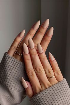 Elevate your look with these gorgeous simple nail ideas using neutral plain colors. This chic design features a soft beige base with a delicate matte finish, perfect for any occasion. The understated elegance of neutral tones ensures that your nails remain classy and versatile while adding a touch of sophistication to your style. Try this minimalistic approach and let your nails make a subtle statement! Beige Color Nails Acrylic, Matt Beige Nails, Nail Ideas Neutral Classy, Minimalist Nails Beige, Pastel Brown Nails, Nails Acrylic Solid Color Simple, Simple Nail Ideas Neutral Colors, Nails Acrylic Simple Classy, Neutral Tone Nails