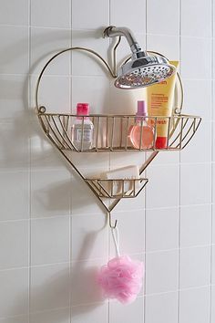 a heart shaped shower caddy with soap and lotion