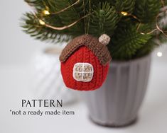 a knitted christmas ornament hanging from a tree in a pot with the words pattern not a ready made item