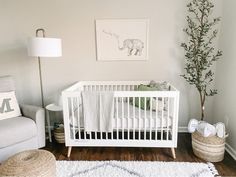 a baby's room with a white crib and rug