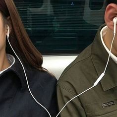 the man and woman are listening to music together