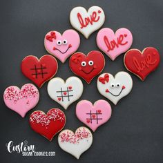 decorated cookies in the shape of hearts with love written on them and eyes painted on