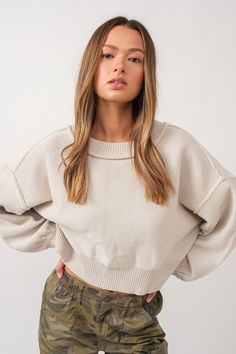 Stay cozy and on-trend with the "Frost" Sweater. This ivory sweater features a unique relaxed fit, balloon sleeves, and crew neckline, complete with seam detail. Its lightweight materials will keep you comfortably warm. Cozy Balloon Sleeve Sweater With Ribbed Cuffs, Casual Sweater With Balloon Sleeves And Ribbed Cuffs, Casual Balloon Sleeve Sweater With Ribbed Cuffs, Casual Soft Knit Sweater With Balloon Sleeves, Balloon Sleeve Sweater For Fall Loungewear, Winter White Crew Neck Cropped Sweater, Trendy Cream Sweater With Ribbed Cuffs, Beige Textured Knit Crew Neck Cropped Sweater, Oversized Beige Cropped Sweater