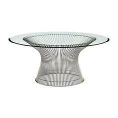 an oval glass table with metal wire on the top and bottom, against a white background