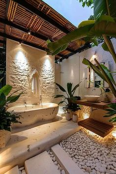 the bathroom is decorated in white and has stone steps leading up to an outdoor bathtub