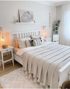 a bedroom with white furniture and decor in it