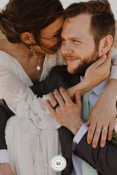 a man and woman are hugging each other