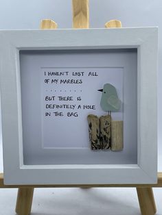 a white frame with a bird on it and a poem written in the bottom right corner