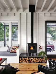 a living room filled with furniture and a fire place in the middle of it's walls