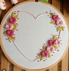 a heart shaped embroidery project with pink flowers