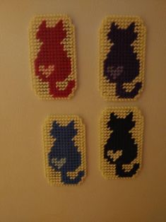 four cross stitch coasters with cats on them in different colors and sizes are shown