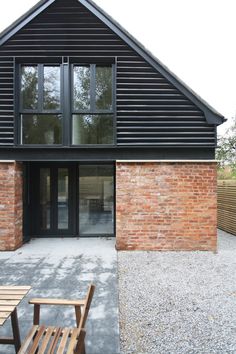 a wooden bench sitting in front of a brick building