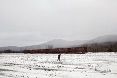 a person standing in the middle of a snow covered field