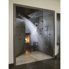 a shower with water coming out of it in a bathroom next to a fire place