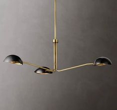 a modern chandelier with three shades of black and gold hanging from the ceiling