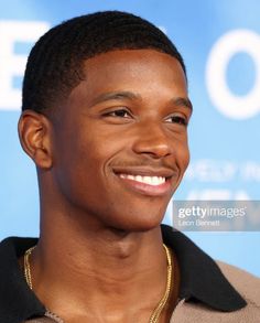 a smiling young man in front of a blue background with the words life on it