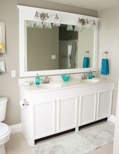 a bathroom with two sinks and a large mirror above the sink is shown in this image