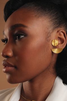 THE HALF a Yellow Sun Baule Stud Earring II is a piece that can stand alone as a statement earring or be worn as a pair. A mix of subtle futurism and traditional design imbue the piece with a classic elegance. Each piece features delicate detailing carefully crafted to mimic the filigree like texture of original Baule bead work. The Baule people are a group indigenous to Western Africa known for their rich brass and gold smithing culture. Each bead is named after a common or proverbial object, s Modern Drop Plug Earrings, Elegant Semi-circle Metal Earrings, Modern Brass Wrap Earrings For Pierced Ears, Elegant Semi-circle Brass Earrings, Elegant Round Metal Ear Cuff, Elegant Semi-circle Pierced Earrings, Elegant Semi-circle Earrings, Elegant Semi-circle Metal Jewelry, Modern Round Single Plug Earring