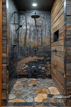 a walk in shower sitting next to a lush green forest filled with leaves and rocks