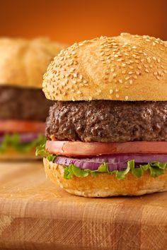 a hamburger sitting on top of a wooden cutting board