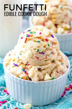 two bowls filled with cookies and sprinkles on top of a blue table cloth