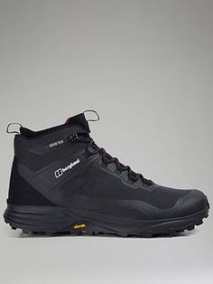 a pair of black hiking boots on a gray background