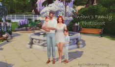 a couple and their child are standing in front of a fountain with flowers on it