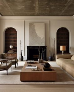 a living room with two couches and a coffee table in front of a fireplace