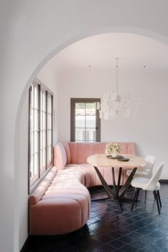 a living room with a couch, table and chairs in it's center area