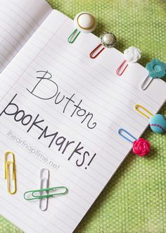 an open book with paper clips and magnets attached to the page that says buttons bookmarks