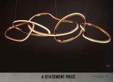 an advertisement for a statement piece with rings hanging from it's sides and the words statement piece below