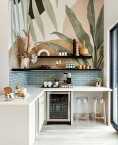 the kitchen is decorated with tropical wallpaper