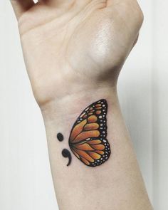 a butterfly tattoo on the wrist is shown in black and orange colors, with bubbles coming out of it