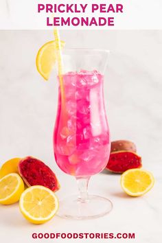 a pitcher filled with pink lemonade next to sliced lemons and pomegranate