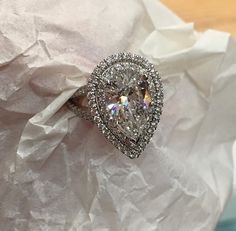 a diamond ring sitting on top of a piece of paper