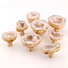 six pieces of white and gold colored glass knobs