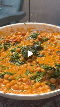 a white bowl filled with beans and spinach